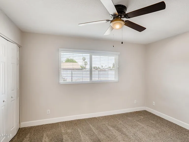 Bedroom 3 is a spacious carpeted room featuring an extra- large closet & great views of lush backyard & pool.