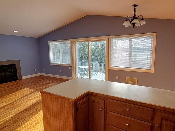 View of LR/DR from kitchen showing gas fireplace