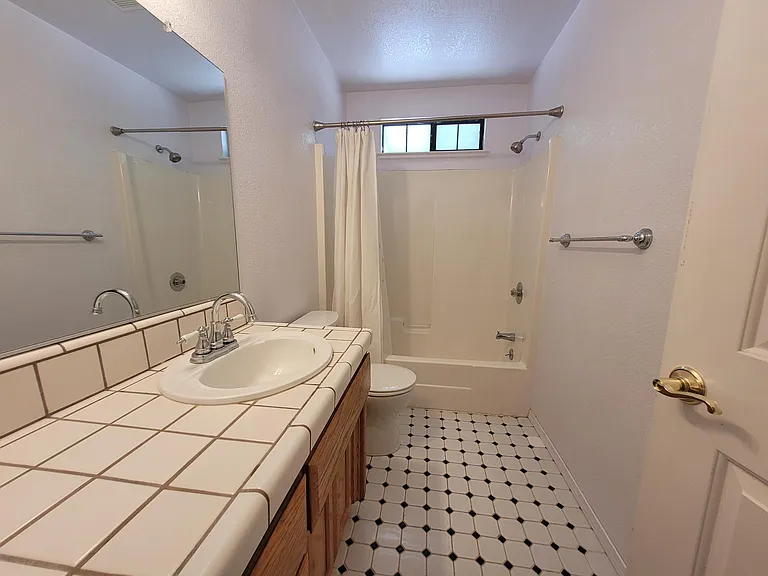 Bath has been updated with white Garnite and new tile floor.
