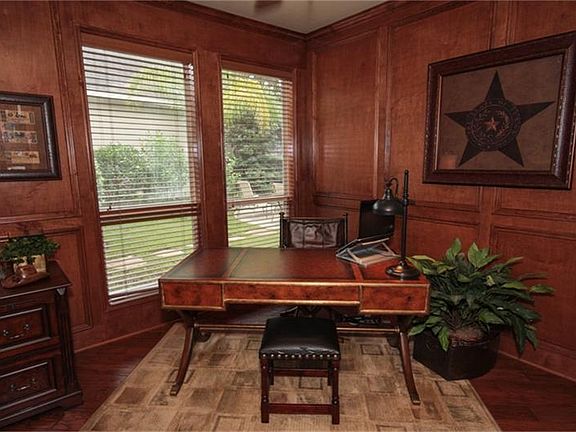  Block paneled study with hardwood floors.