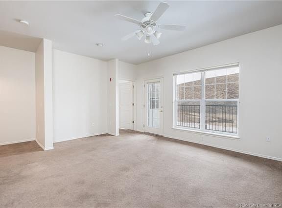 Living Room looking toward Patio with TV nook. Door to Bedroom in the center.