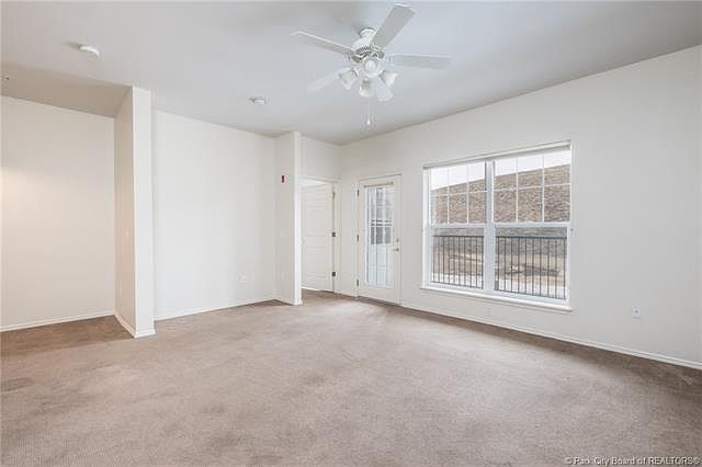 Living Room looking toward Patio with TV nook. Door to Bedroom in the center.