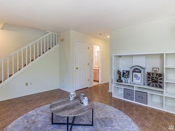 Hallway in center leads to kitchen, laundry and garage.  Open door is the powder room.  Extra storage under the stairs.