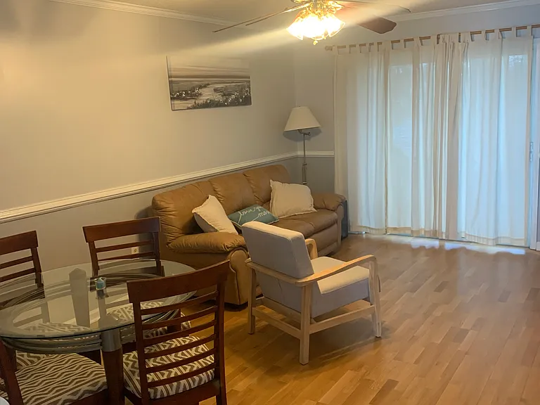 Living Room with side view of dining room table and chairs