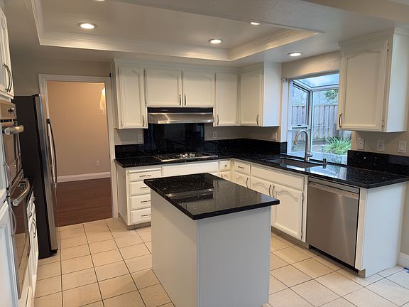 Kitchen with newly refinished cabinets, new kitchen faucet, and Bosch dishwasher