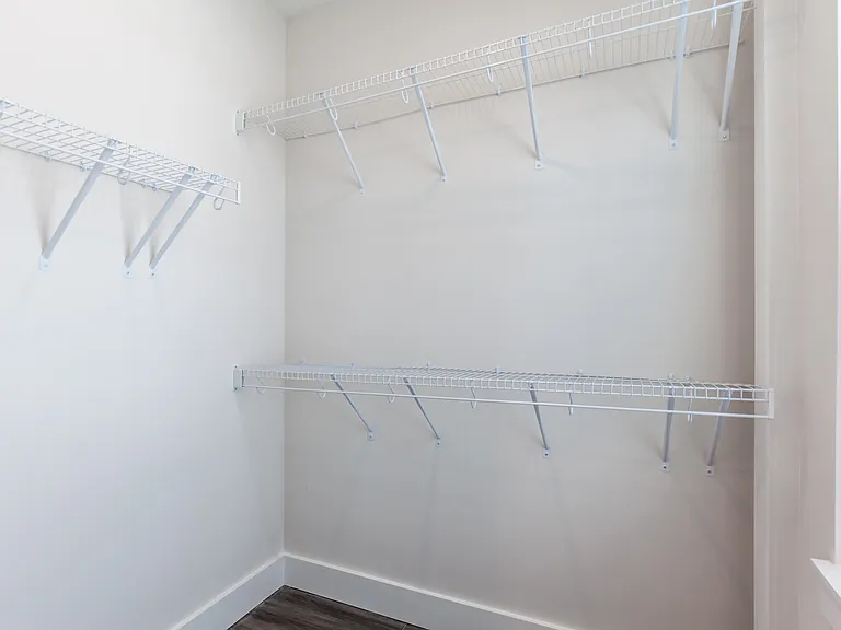 Nice walk-in closet has a large window for natural light.