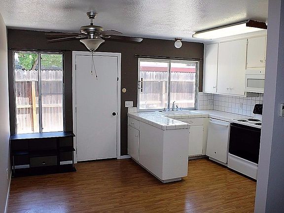 Dining Area and rear Patio access connect to the Kitchen.