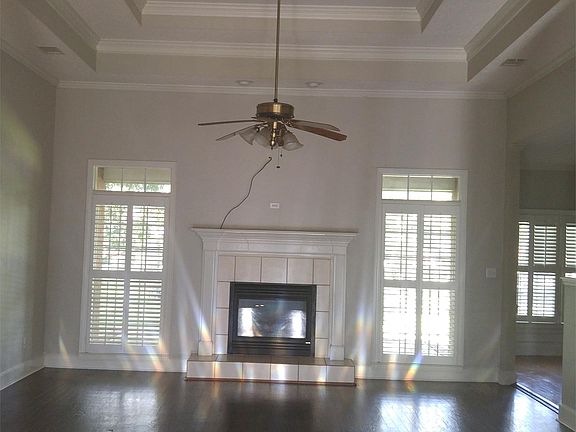 Living room with double tray ceiling and gas log fireplace.