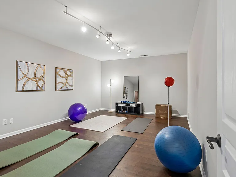 Also on the lower level is a large flex room, currently utilized as a fitness studio, offering endless possibilities as a home gym, theatre room (perfect), playroom, hobby space, second office, or additional recreation area.