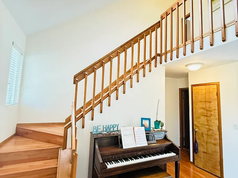 Staircase, high ceilings, skylight, and modern chandelier