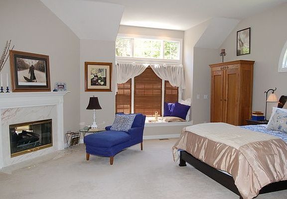 Large luxury 1st floor master with fireplace and window seat w/view of preserv