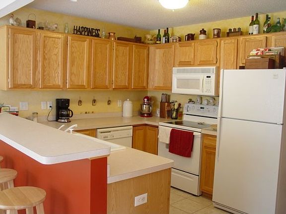 Open Kitchen with snackbar and tile floors