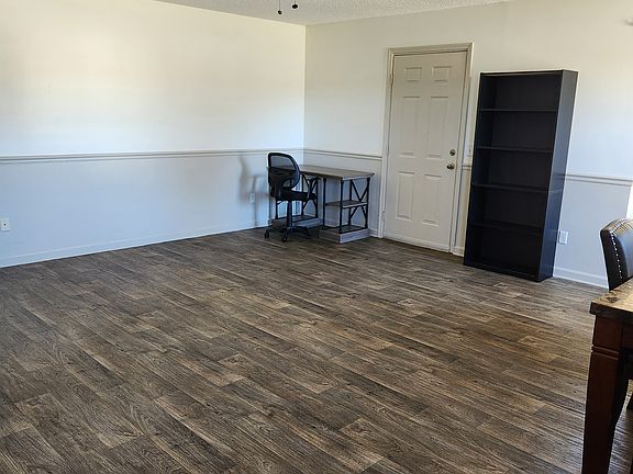 Living room with desk, chair and bookcase (no couch).