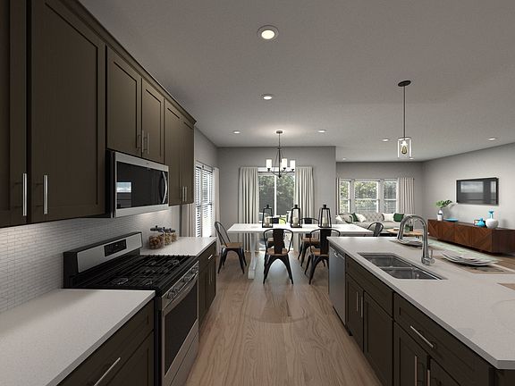 The open-concept floorplan connects the kitchen to the dining and living areas.