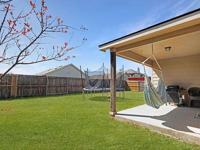 The covered patio has plenty of room for grilling and socializing