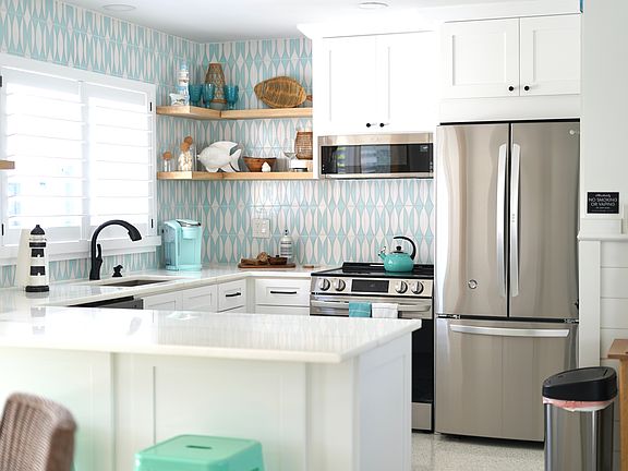 Newly remodeled Kitchen with marble countertops and wood cabinets.