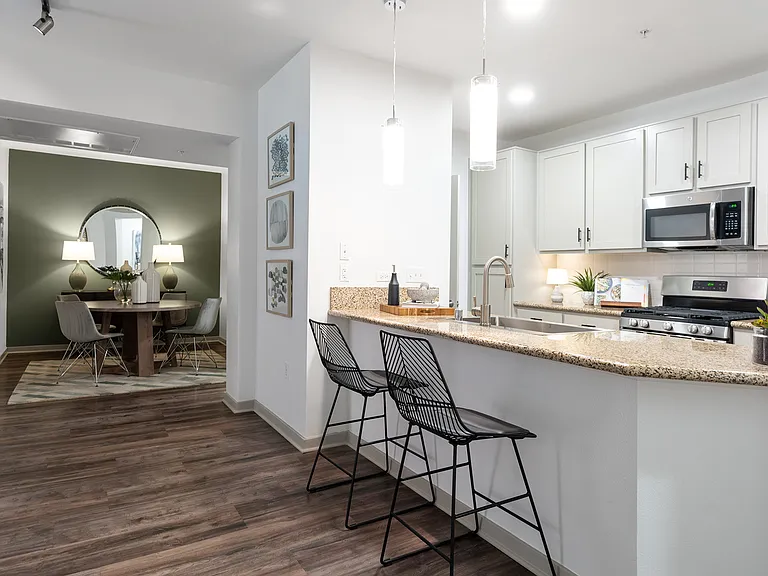 Kitchens include luxury vinyl plank flooring, gas ranges, and stainless steel appliances