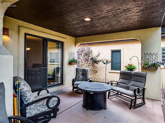 Cozy covered patio in the backyard is a great place to relax and enjoy the weath