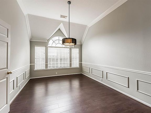 Formal Dining room to the right of the entry with gorgeous moldings and stylish lighting.
