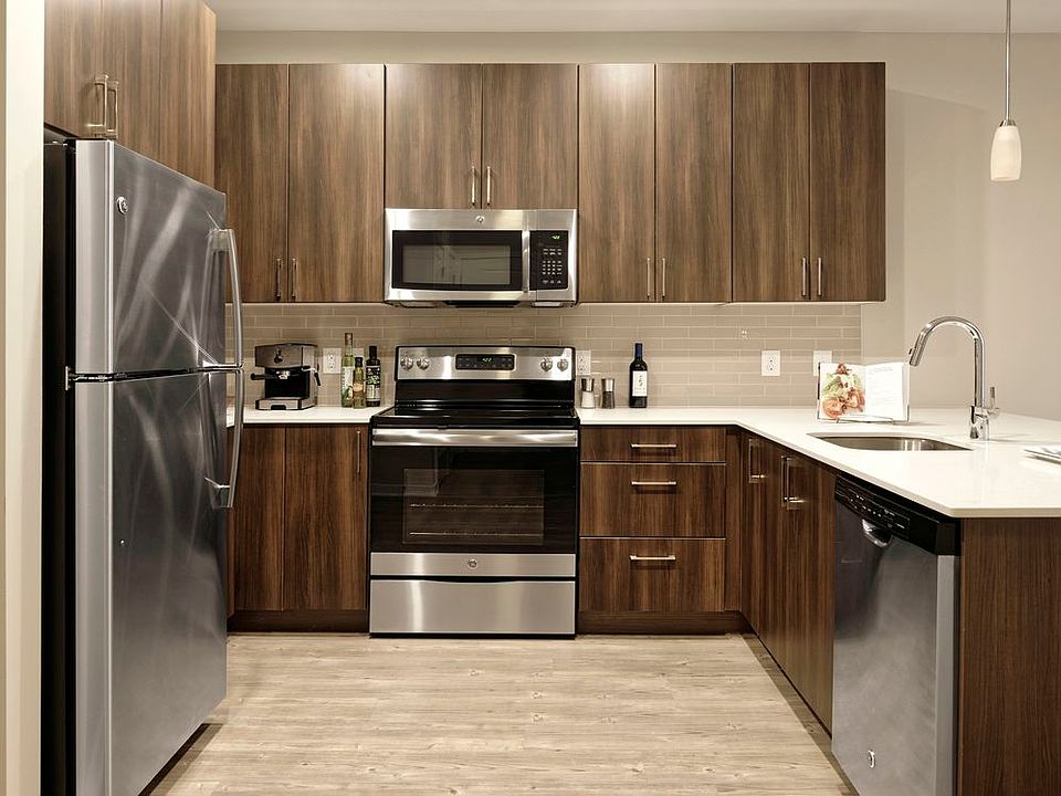 Upgraded Finish Package open concept kitchen with granite countertops, stainless steel appliances and hard surface flooring