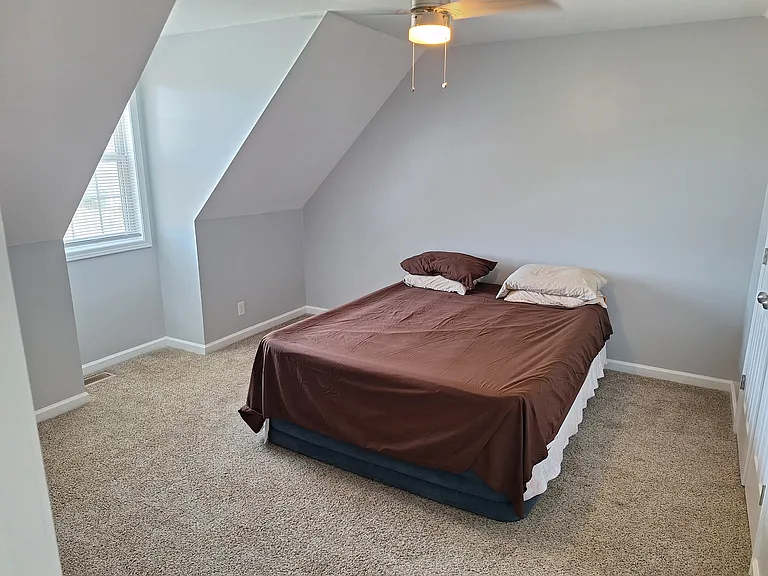 Bright upstairs bedroom #2 with ceiling fan.