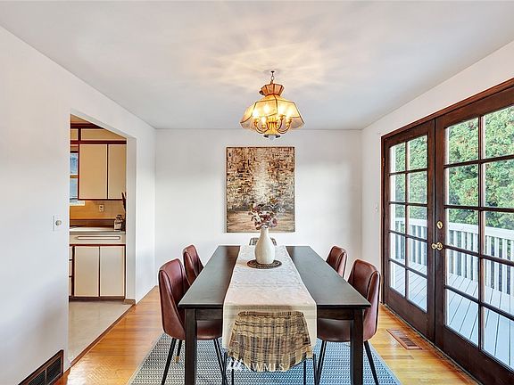 Large and sunny dining area with french doors to wrap around deck.