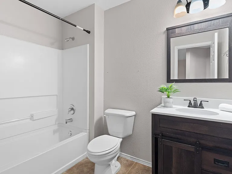 Upstairs secondary bathroom updated with vanity, mirror, and light fixture