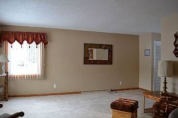 The very well lit and spacious living area.  This room opens to the front entry way and the dining and kitchen areas as well.  