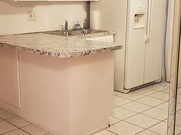 Kitchen: storage underneath counter, stools look great here, pantry area, storage closet, opens to covered patio