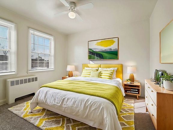 Immerse yourself in the warmth of this sunlit bedroom, combining comfort with stylish design.