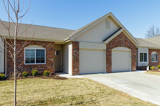 Single car garage with garage door opener and driveway parking.