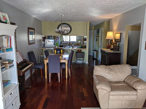 From the sliding glass doors on second level looking past main living area towards dining area and kitchen