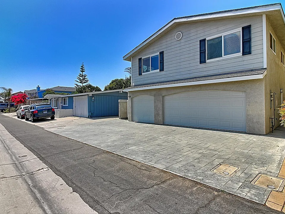 Spacious entry driveway with additional parking space behind single garage. Garage has direct private access to interior courtyard.