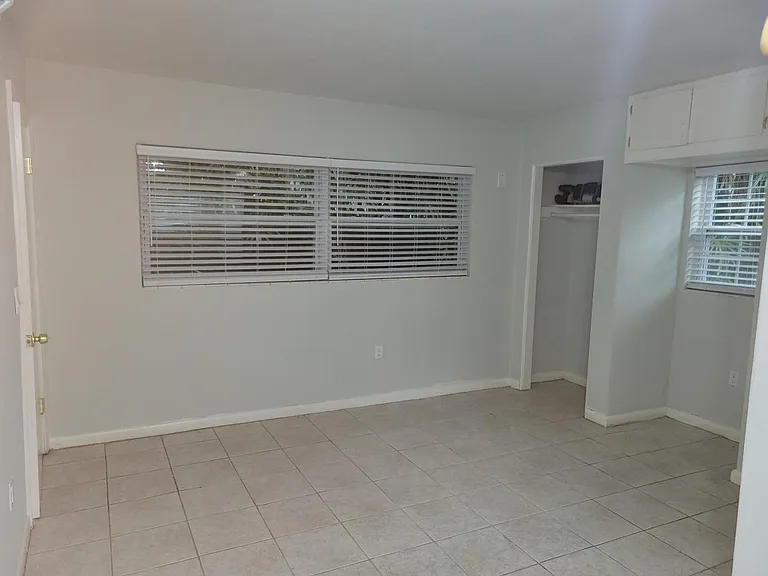 Large bedroom with all new paint and window treatments.