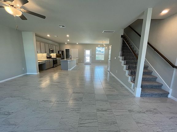 Main living area features open floor-plan. Dining area. Walk-in pantry. Half bathroom. Under-stairs storage closet.