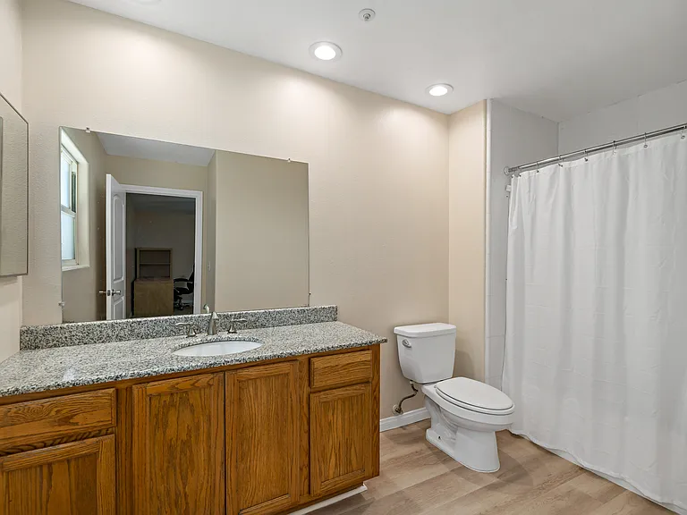 Private Bathroom with modern comforts that boast clean lines, newly renovated fixtures, and ample storage space in stylish cabinets.