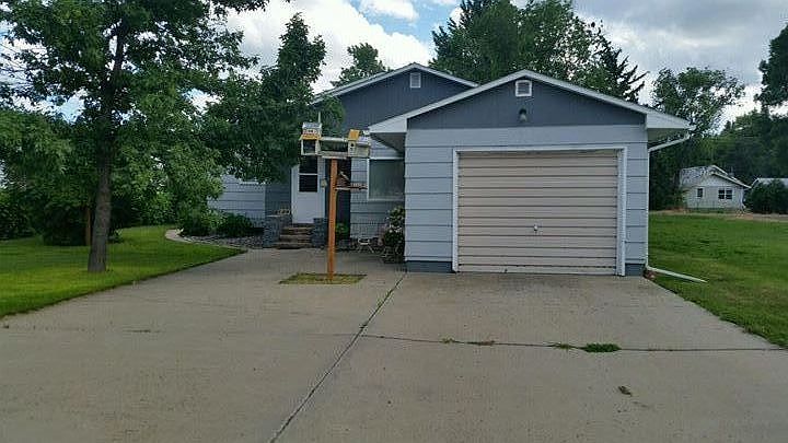 Front of Home : Charming curbside appeal with a large concrete slab for parking.