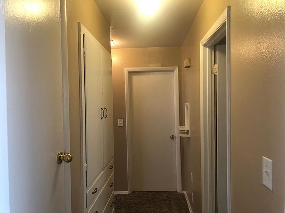 Hallway with storage cabinets and drawers