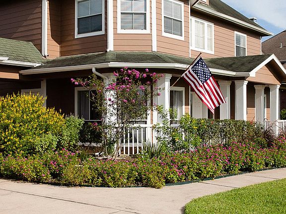   Lush landscaping and an over sized covered front porch offer great curb appeal.
