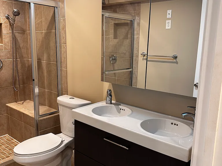Full bath with double shower head and double vanity sink in the basement
