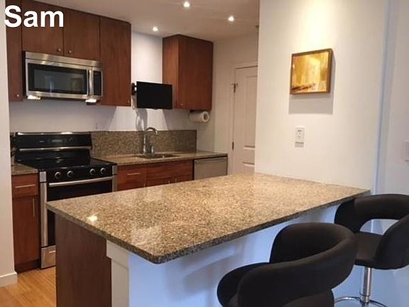 Full kitchen with fridge, dishwasher, microwave and stove