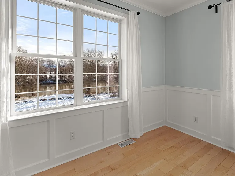Formal sitting area and dining room. View of the Winooski River.