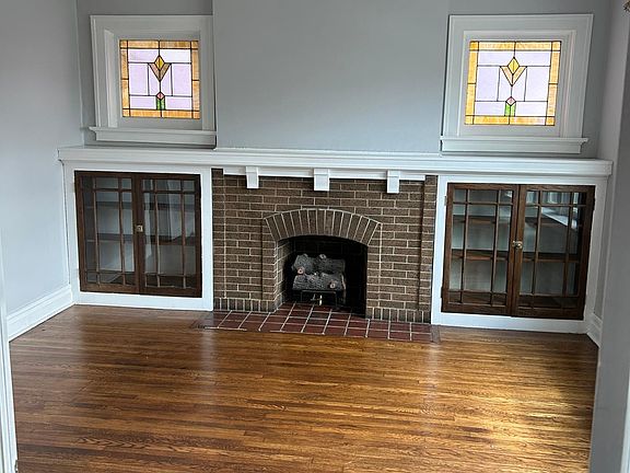 Living Space with Fireplace, Stain glass, and French doors
