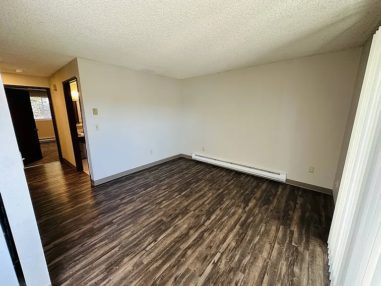 This living area features durable vinyl plank flooring and a flexible layoutperfect for relaxing or entertaining.