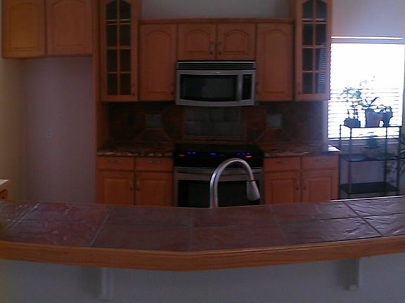 Panoramic view of entry, dining room, and kitchen