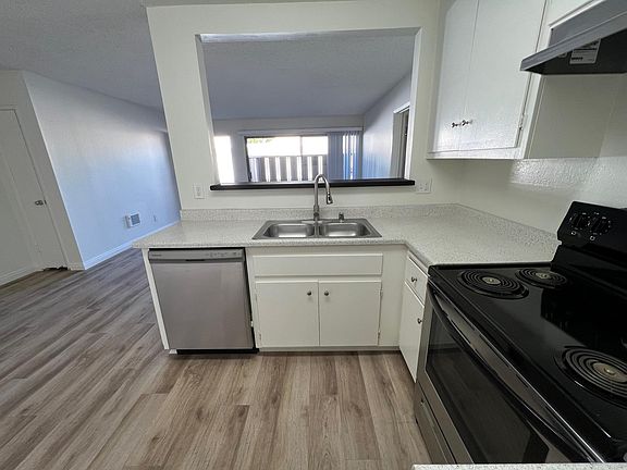 Standing where the refrigerators goes. Looking outward toward the patio and the front entry door. Downstairs 2x2.