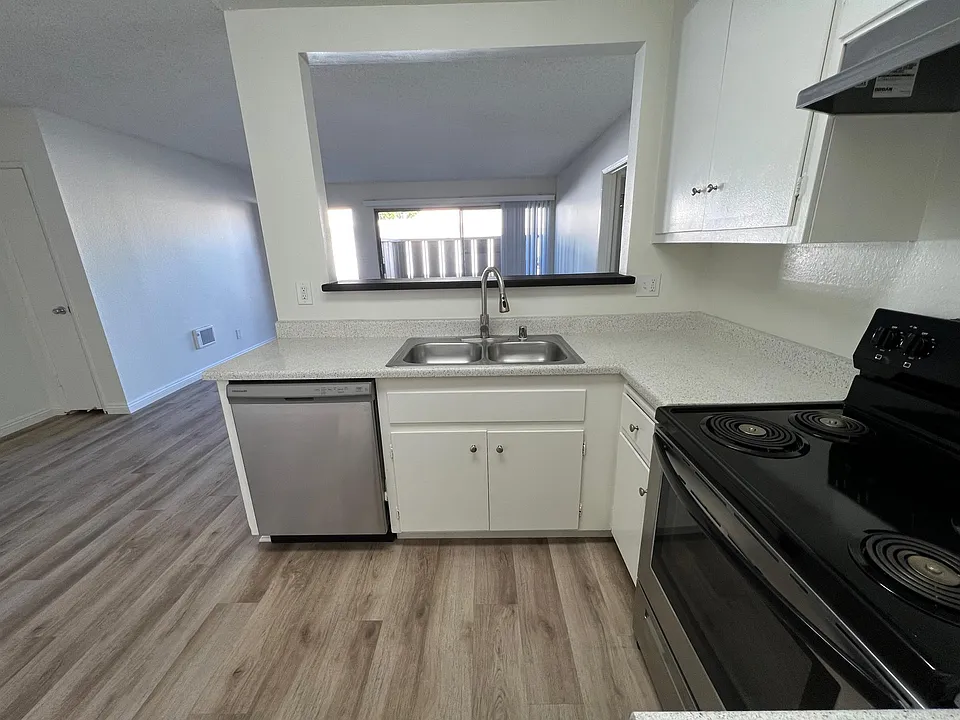 Standing where the refrigerators goes. Looking outward toward the patio and the front entry door. Downstairs 2x2.