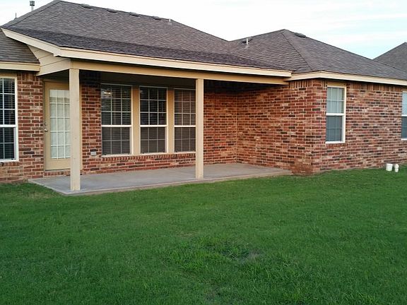 Back of home with covered patio