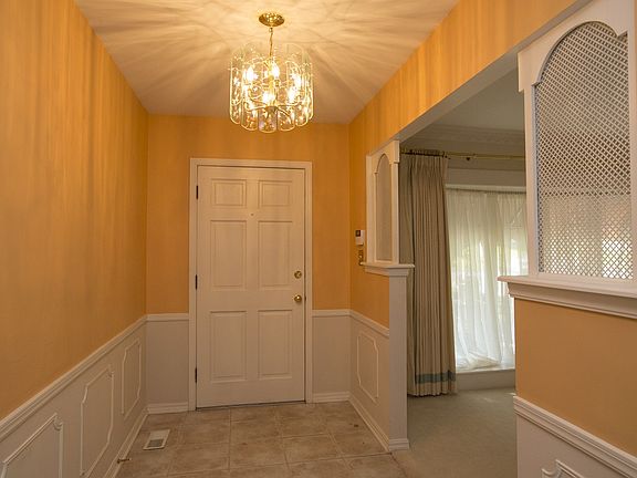 Foyer opens to Formals & Den