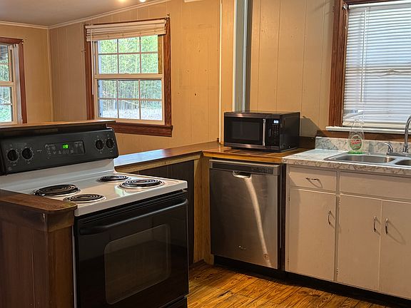 Kitchen including stove, refrigerator, and dishwasher.